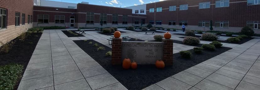 Londonderry High School courtyard with pumpkins and benches, showcasing a welcoming atmosphere.